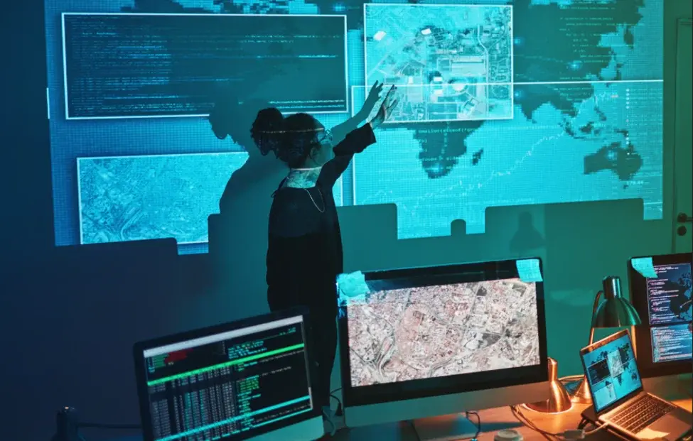 Security analyst reviewing digital maps and intelligence data, illustrating how threat assessments help UHNW families identify risks and plan appropriate protection.